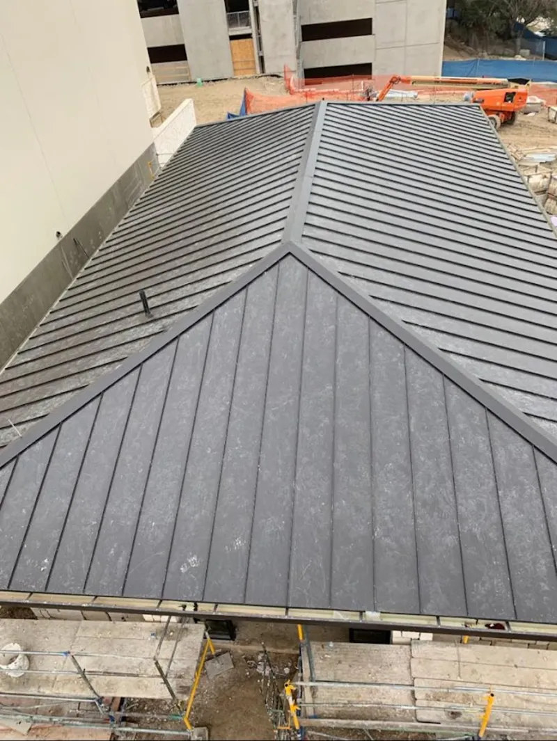 Commercial metal roof construction with crane equipment in Eustis