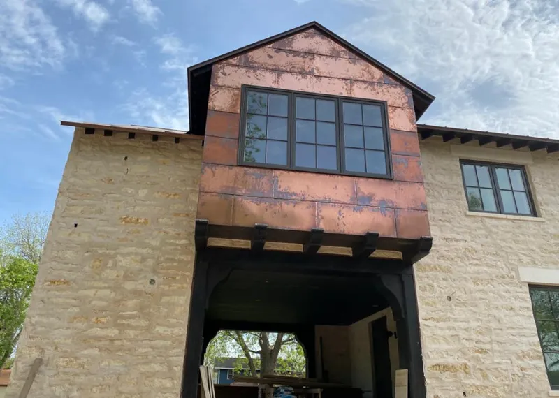Copper metal panel facade on a stone building for Metal Roof Coating in Eustis