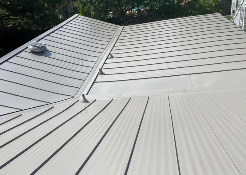 Solar attic fan installed on a metal roof for Roof Ventilation in Eustis